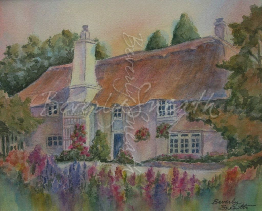 An English cottage with a thatched roof and chimney is surrounded by flowers and trees.