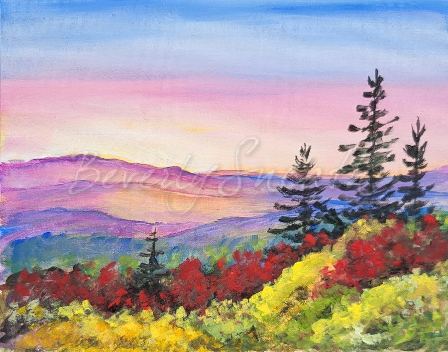 Bright sky, mountains, tall evergreens, Fall treetops with red and yellow and green