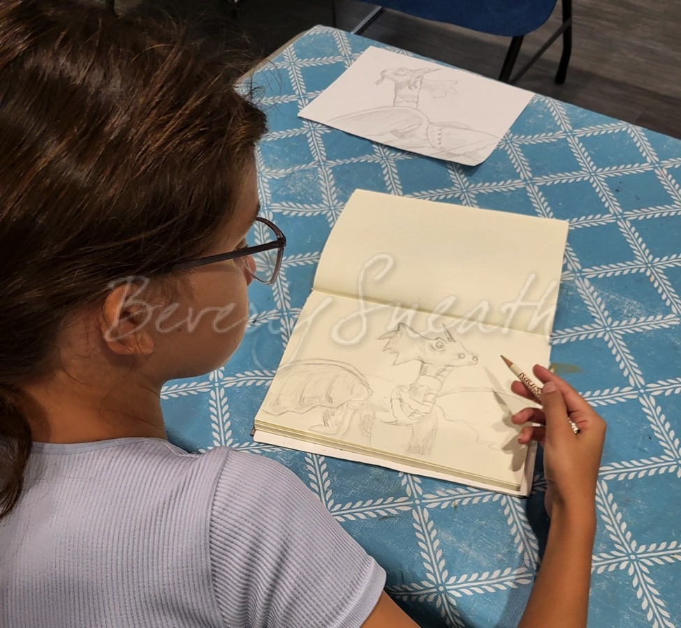 girl drawing in sketchbook