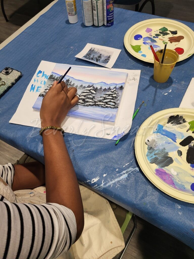 girl painting an acrylic winter landscape