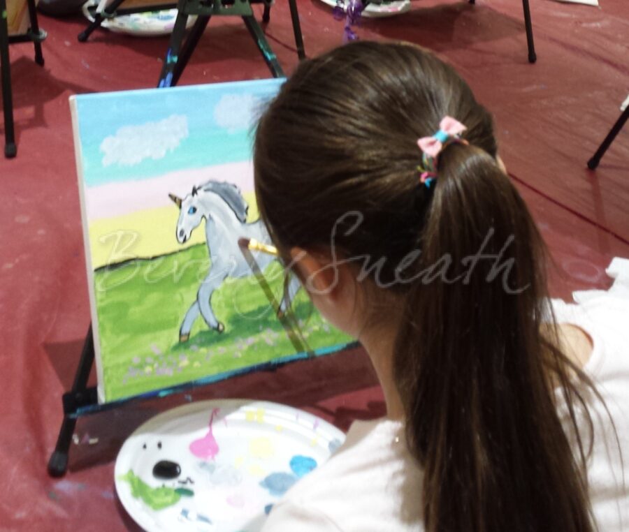 girl painting a unicorn