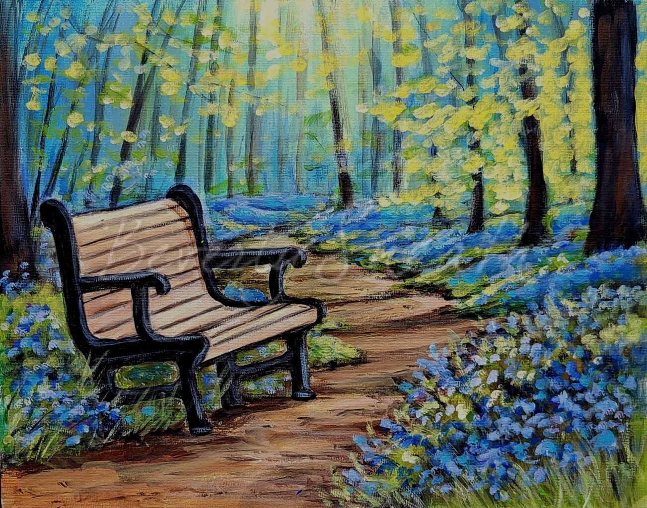 Bench beside a path in the forest with bluebell flowers border