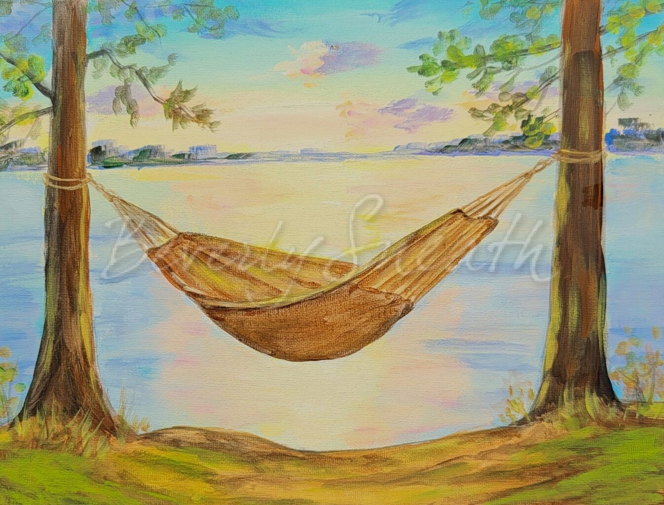 Hammock strung between two trees overlooking a lake