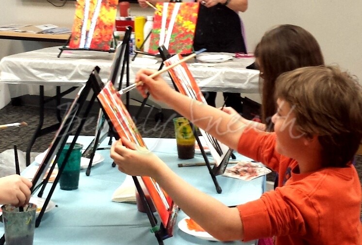 Kids painting at easels